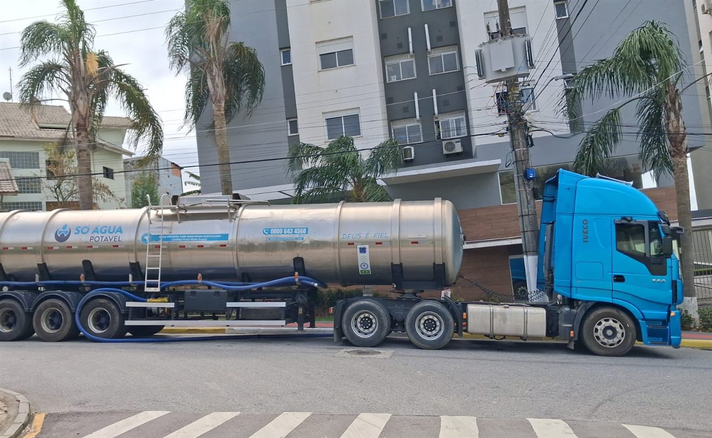 Carreta-tanque de inox da Só Água Potável entregando água potável em rua de condomínios em Santa Catarina